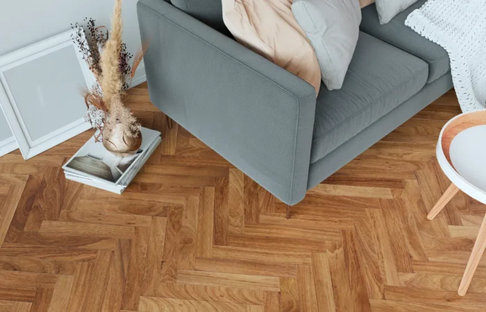 cozy-modern-living-room-corner-with-wooden-parquet-flooring-featuring-gray-sofa-stylish-coffee-table-decorative-frames-booksxaxa